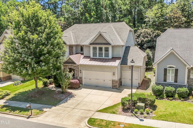 1413 Lily Creek Dr, Cary, NC 27518 - craftsman-style home featuring stone siding, a standing seam roof, a garage, concrete driveway, and a front yard