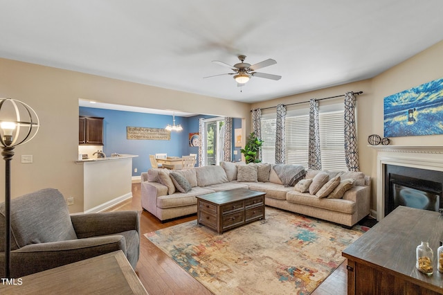 1413 Lily Creek Dr, Cary, NC 27518 - living room featuring wood-type flooring, ceiling fan, and a glass covered fireplace