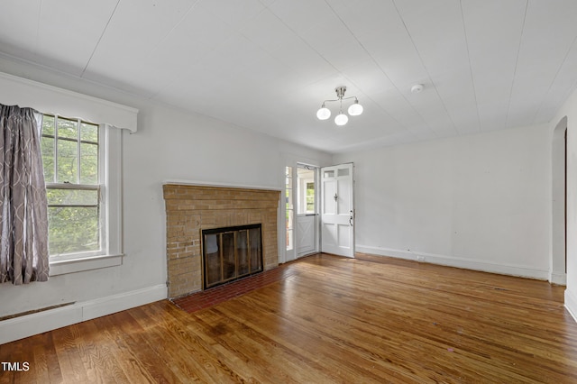 2715 E Geer St, Durham, NC 27704 - unfurnished living room featuring wood finished floors and a fireplace