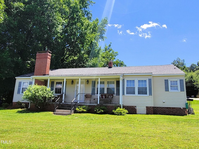 411 W Raleigh St, Siler City, NC 27344 - ranch-style home with crawl space, a porch, a front yard, and a chimney