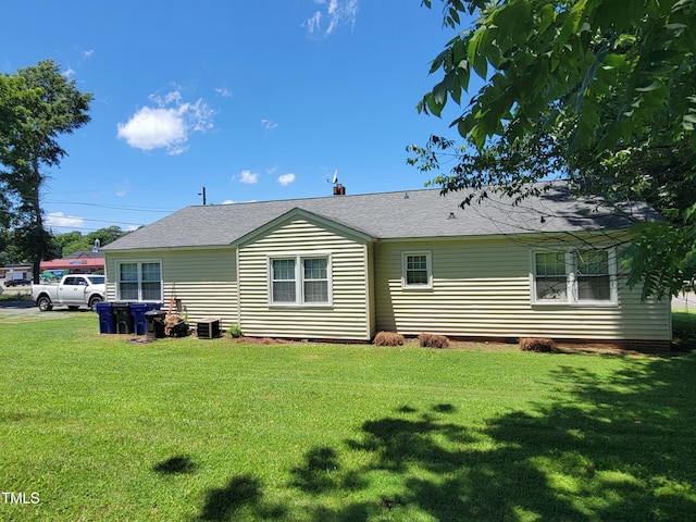 411 W Raleigh St, Siler City, NC 27344 - back of property with a lawn, roof with shingles, and crawl space