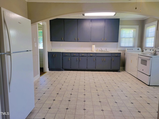 411 W Raleigh St, Siler City, NC 27344 - kitchen with freestanding refrigerator, washing machine and clothes dryer, ornamental molding, and light countertops