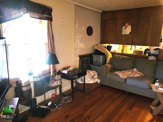 411 W Raleigh St, Siler City, NC 27344 - living area featuring wood finished floors, crown molding, and a fireplace