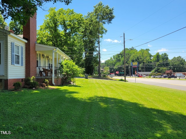 411 W Raleigh St, Siler City, NC 27344 - view of grassy yard featuring covered porch
