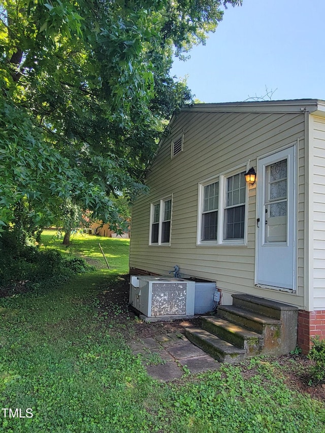 411 W Raleigh St, Siler City, NC 27344 - view of side of home with entry steps and a central air condition unit