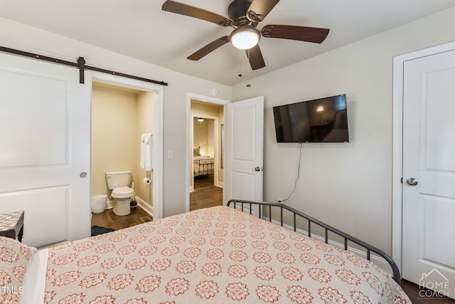 309 E End Ave, Durham, NC 27703 - bedroom with dark wood-type flooring, a barn door, connected bathroom, and a ceiling fan