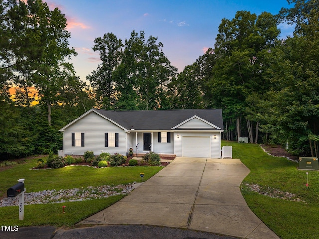 200 Cornerstone Dr, Franklinton, NC 27525 - ranch-style house featuring a garage, concrete driveway, a front lawn, and view of wooded area