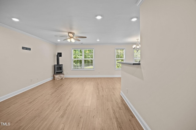 200 Cornerstone Dr, Franklinton, NC 27525 - unfurnished living room featuring a wood stove, crown molding, light wood-style floors, recessed lighting, and a ceiling fan