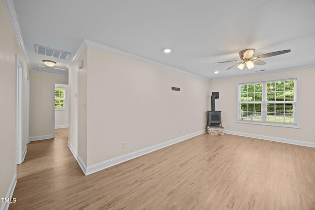 200 Cornerstone Dr, Franklinton, NC 27525 - unfurnished living room with a wood stove, ornamental molding, light wood finished floors, a ceiling fan, and recessed lighting
