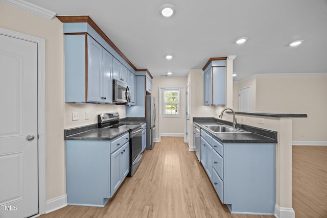 200 Cornerstone Dr, Franklinton, NC 27525 - kitchen with stainless steel appliances, dark countertops, light wood-style flooring, a peninsula, and recessed lighting