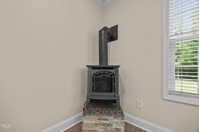 200 Cornerstone Dr, Franklinton, NC 27525 - detailed view of crown molding, wood finished floors, and a wood stove