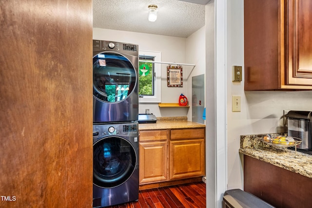 206 Lisa Dr, Carrboro, NC 27510 - laundry room with stacked washer / dryer, dark wood-style flooring, and a textured ceiling