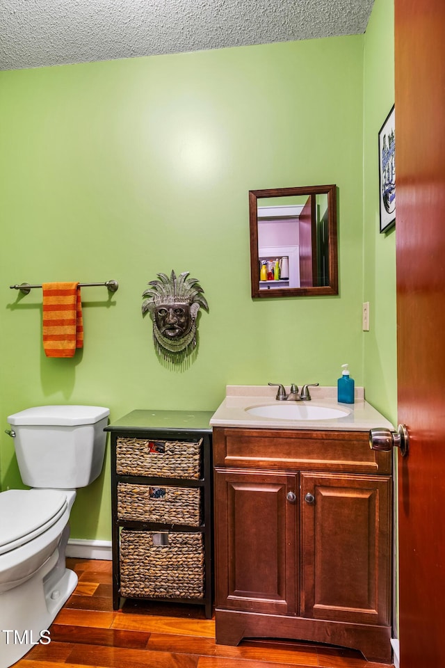 206 Lisa Dr, Carrboro, NC 27510 - bathroom featuring vanity, wood finished floors, and a textured ceiling