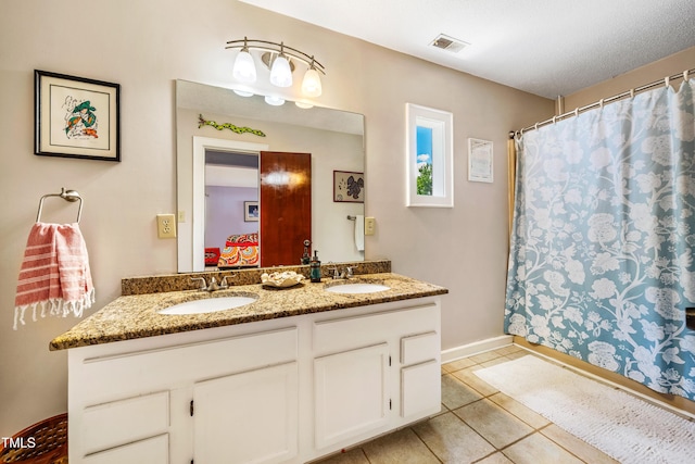 206 Lisa Dr, Carrboro, NC 27510 - full bath featuring double vanity, tile patterned floors, and a shower with shower curtain
