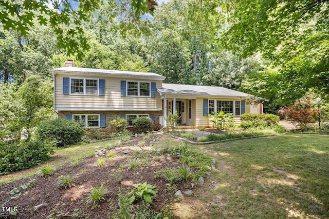 619 Ashe Ave, Cary, NC 27511 - tri-level home featuring a chimney and a front yard