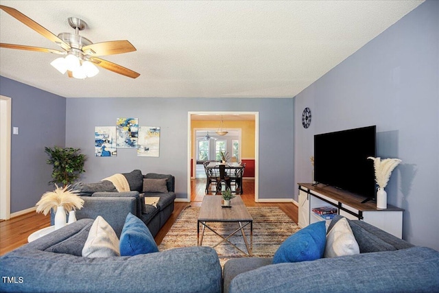 619 Ashe Ave, Cary, NC 27511 - living room with ceiling fan, wood finished floors, and a textured ceiling