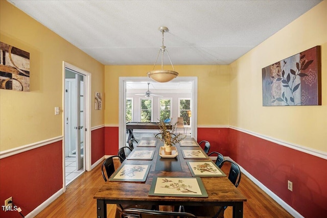 619 Ashe Ave, Cary, NC 27511 - dining area featuring wood finished floors, a ceiling fan, and a textured ceiling