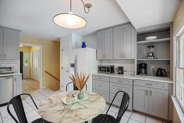 619 Ashe Ave, Cary, NC 27511 - kitchen featuring gray cabinets, appliances with stainless steel finishes, light tile patterned floors, and light countertops