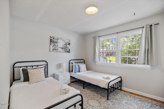619 Ashe Ave, Cary, NC 27511 - bedroom with wood finished floors and a textured ceiling