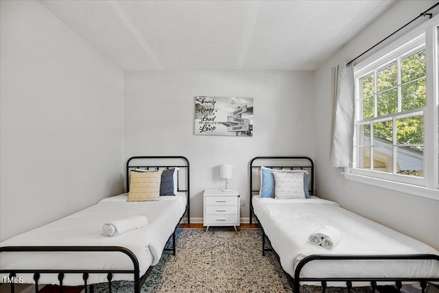 619 Ashe Ave, Cary, NC 27511 - bedroom with wood finished floors and a textured ceiling