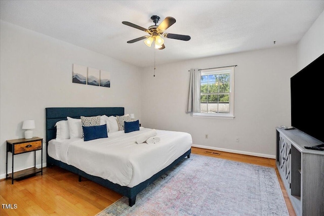 619 Ashe Ave, Cary, NC 27511 - bedroom with light wood finished floors and ceiling fan