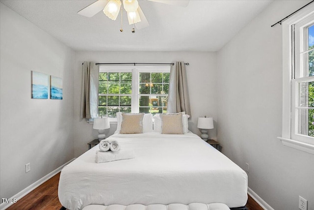 619 Ashe Ave, Cary, NC 27511 - bedroom featuring multiple windows, wood finished floors, and ceiling fan