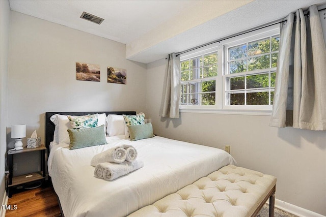619 Ashe Ave, Cary, NC 27511 - bedroom featuring multiple windows and wood finished floors