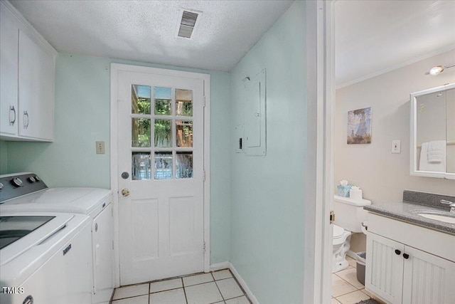 619 Ashe Ave, Cary, NC 27511 - washroom with cabinet space, light tile patterned flooring, separate washer and dryer, a textured ceiling, and electric panel