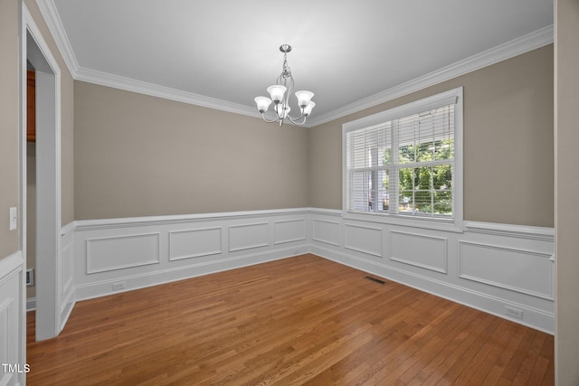 1012 Palace Garden Way, Raleigh, NC 27603 - unfurnished room featuring a chandelier, crown molding, light wood-type flooring, and wainscoting