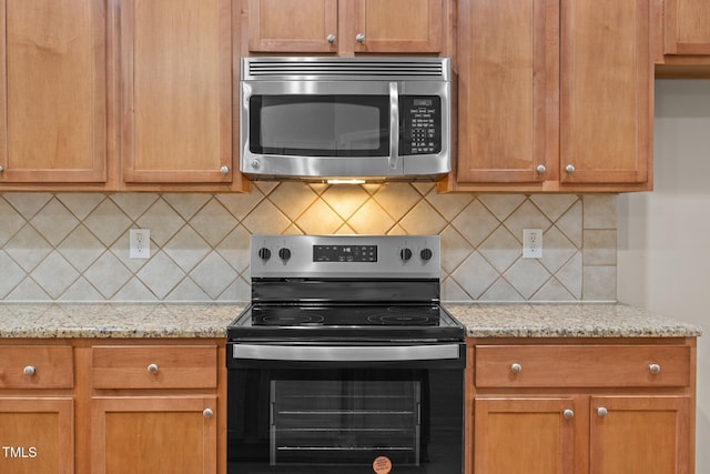 1012 Palace Garden Way, Raleigh, NC 27603 - kitchen with appliances with stainless steel finishes, backsplash, and light stone counters