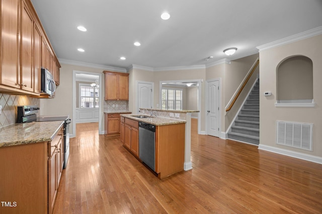 1012 Palace Garden Way, Raleigh, NC 27603 - kitchen with appliances with stainless steel finishes, backsplash, light wood-style floors, recessed lighting, and light stone countertops