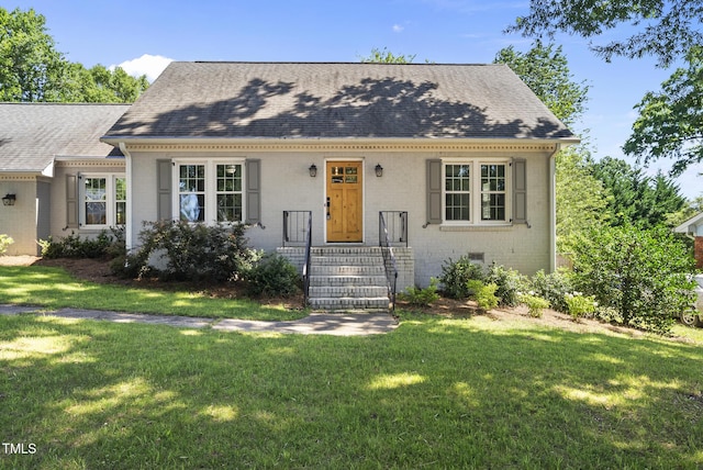 405 E Millbrook Rd, Raleigh, NC 27609 - view of front of house with a front lawn, a shingled roof, and brick siding