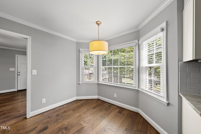 405 E Millbrook Rd, Raleigh, NC 27609 - unfurnished dining area featuring dark wood-style flooring, healthy amount of natural light, and ornamental molding