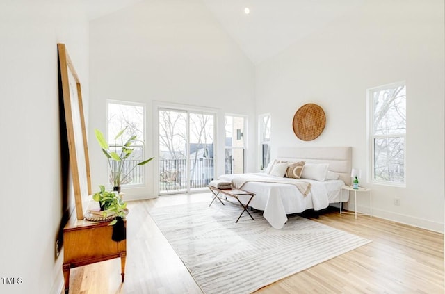 322 S Dixon Ave Unit R, Cary, NC 27511 - bedroom with access to exterior, high vaulted ceiling, and wood finished floors