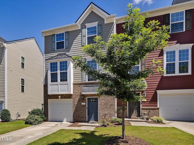 215 Brier Summit Pl, Durham, NC 27703 - townhome / multi-family property featuring concrete driveway, brick siding, a standing seam roof, a garage, and a metal roof