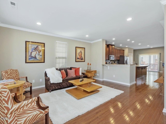 215 Brier Summit Pl, Durham, NC 27703 - living area featuring dark wood finished floors, recessed lighting, and ornamental molding