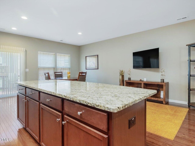 215 Brier Summit Pl, Durham, NC 27703 - kitchen with light wood finished floors, light stone countertops, recessed lighting, and a kitchen island