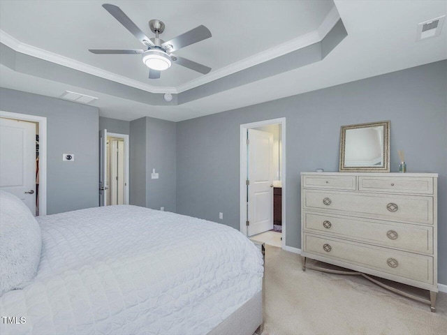 215 Brier Summit Pl, Durham, NC 27703 - bedroom featuring a raised ceiling, light colored carpet, connected bathroom, ornamental molding, and ceiling fan