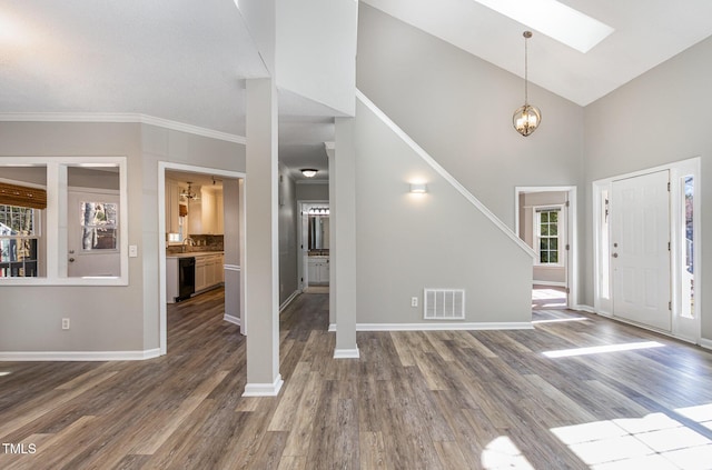 112 Solstice Cir, Cary, NC 27513 - entrance foyer with healthy amount of natural light, wood finished floors, a chandelier, crown molding, and a towering ceiling
