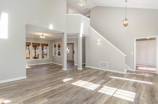 112 Solstice Cir, Cary, NC 27513 - foyer entrance with high vaulted ceiling, wood finished floors, stairs, and a chandelier