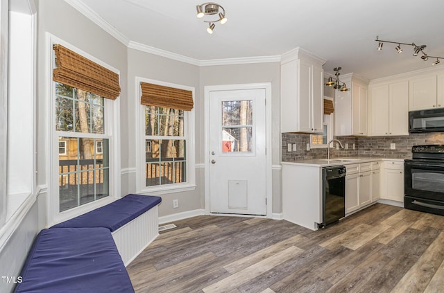 112 Solstice Cir, Cary, NC 27513 - kitchen with black appliances, white cabinetry, light countertops, and crown molding