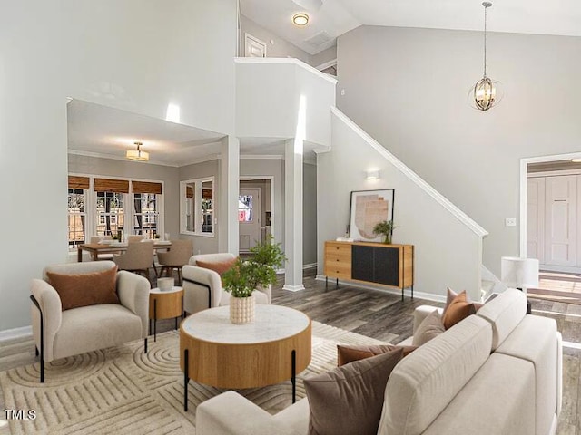 112 Solstice Cir, Cary, NC 27513 - living area with high vaulted ceiling, wood finished floors, stairs, and a chandelier