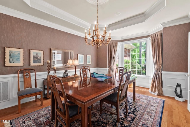 3606 Dairy Pond Pl, Durham, NC 27705 - dining area with a chandelier, wainscoting, crown molding, light wood finished floors, and a raised ceiling
