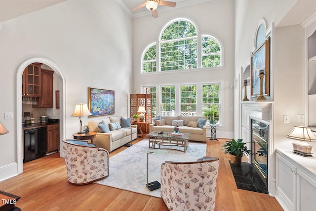 3606 Dairy Pond Pl, Durham, NC 27705 - living area featuring a high ceiling, crown molding, healthy amount of natural light, light wood-style flooring, and a ceiling fan