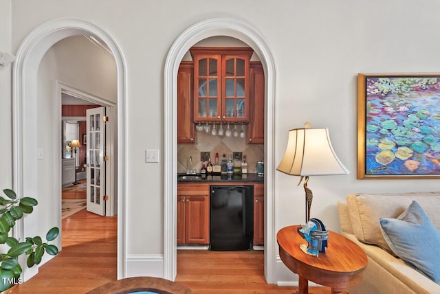 3606 Dairy Pond Pl, Durham, NC 27705 - indoor dry bar with fridge, light wood-style floors, and backsplash