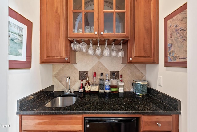 3606 Dairy Pond Pl, Durham, NC 27705 - kitchen with dishwashing machine, backsplash, glass insert cabinets, brown cabinets, and dark stone counters