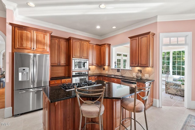 3606 Dairy Pond Pl, Durham, NC 27705 - kitchen featuring stainless steel appliances, a center island, arched walkways, light tile patterned floors, and crown molding