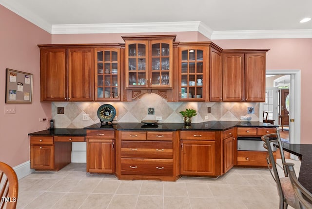 3606 Dairy Pond Pl, Durham, NC 27705 - kitchen featuring backsplash, brown cabinetry, glass insert cabinets, and ornamental molding