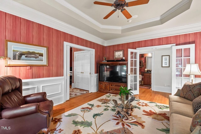 3606 Dairy Pond Pl, Durham, NC 27705 - living area featuring wood finished floors, a tray ceiling, ceiling fan, crown molding, and french doors