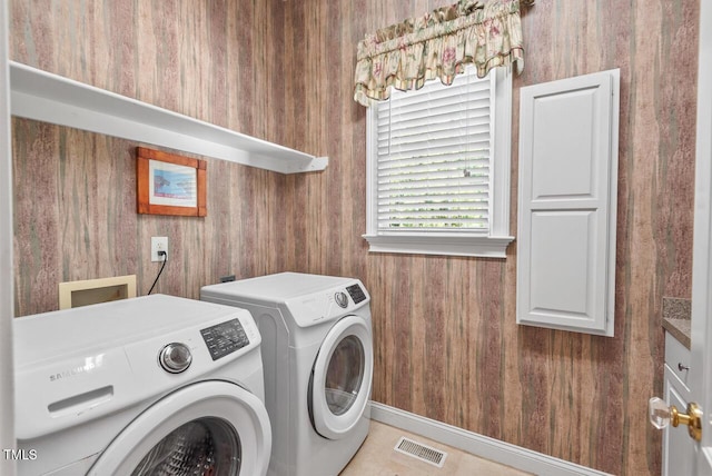 3606 Dairy Pond Pl, Durham, NC 27705 - laundry room with washer and clothes dryer, cabinet space, and wooden walls
